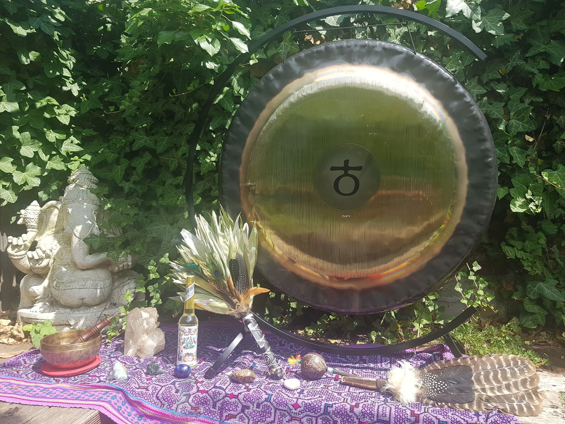a gong, tibetan bowl and shamanic tools standing outside in nature