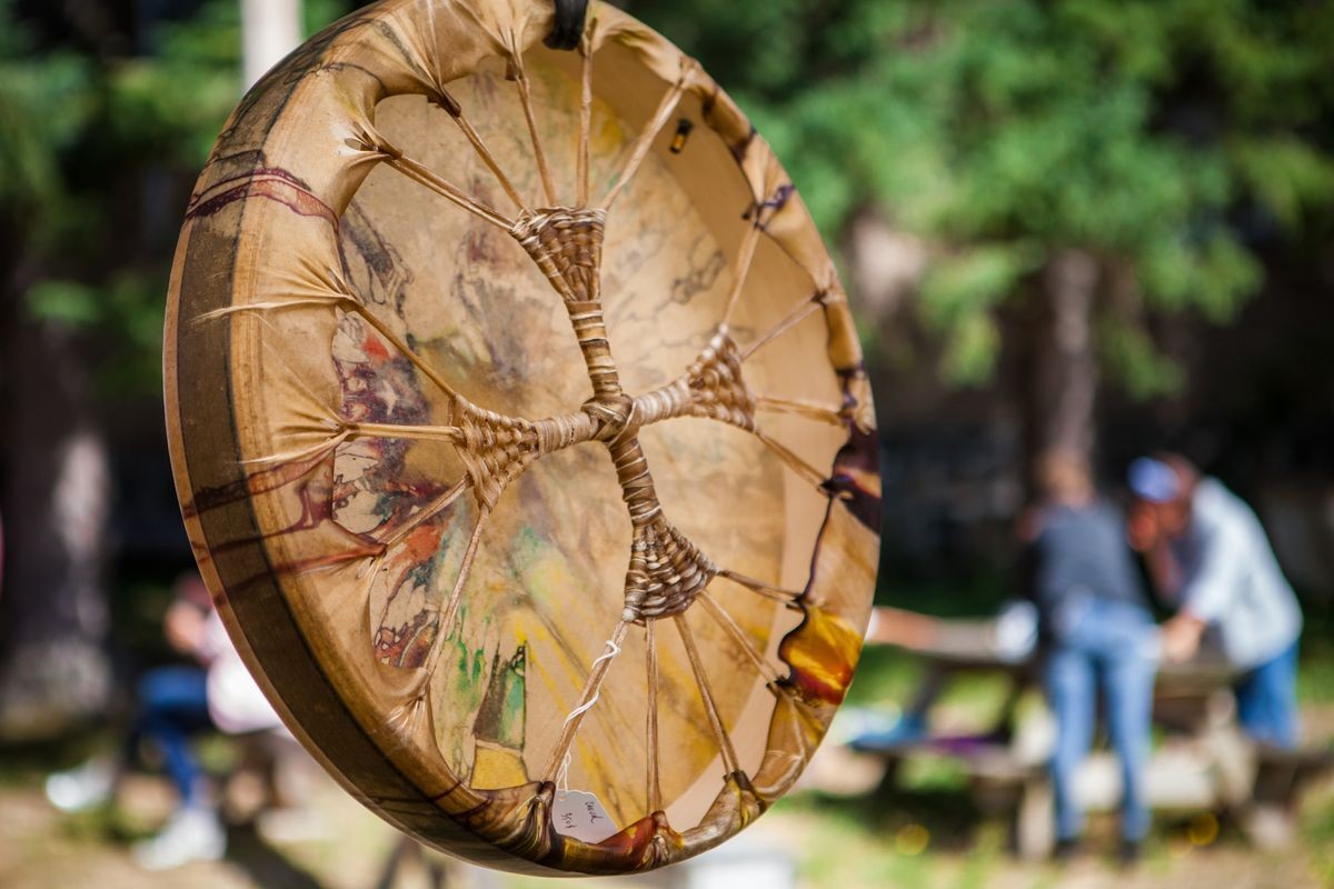 Beautiful and colorful shamanic drum being exhibited outdoors in a local festival - 1/3 - Closeup picture with a blurry background