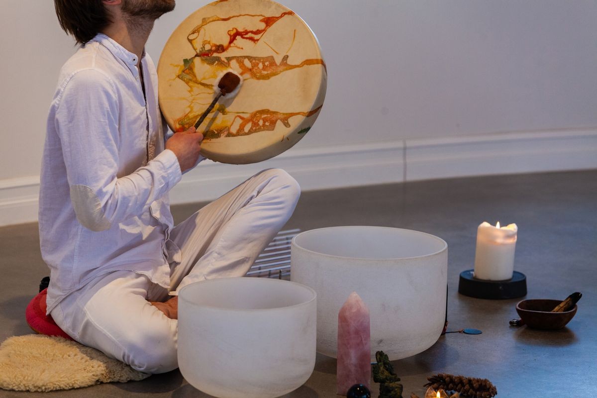 man playing shamanic drum